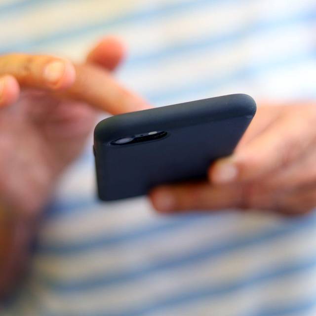 Eine Frau tippt auf einem Smartphone